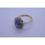 18ct yellow gold dress rings with central amethyst surrounded diamond chips, marked 750, size K, app