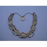 9ct yellow gold fancy bracelet with heart shaped links, heart shaped clasp and safety chain, marked