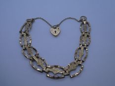 9ct yellow gold fancy bracelet with heart shaped links, heart shaped clasp and safety chain, marked