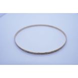 9ct yellow gold circular bangle, 7cm diameter marked 375, with engraved details, approx 3.8g