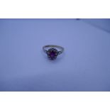 9ct yellow gold ruby and paste set cluster ring with central oval mixed cut ruby surrounded clear st