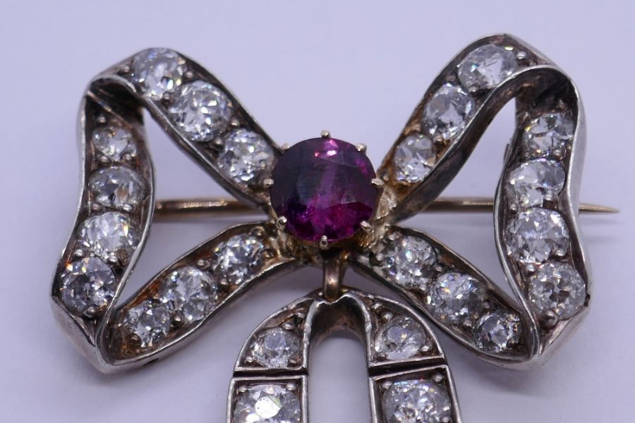 An impressive Victorian ruby and diamond brooch, with form of a bow with central round cut ruby surr - Image 6 of 8