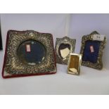 A miniature silver photoframe, also with an Edwardian silver frame heavily embossed with a heart cen