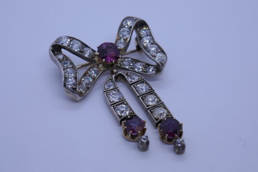 An impressive Victorian ruby and diamond brooch, with form of a bow with central round cut ruby surr - Image 2 of 8