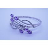 Contemporary 14K white gold hinged bracelet set with diamond chips and amethyst set on decorative ar