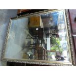 A modern gilt wall mirror with bevelled glass, 127 x 99 cms