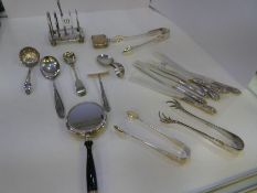 A silver toast rack by Mappin and Webb, on four ball feet. With a heavily decorated Victorian Vesta