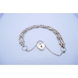 9ct yellow gold three bar gate link bracelet with heart shaped padlock clasp; marked 375 and safety