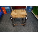 An oak rush seated stool