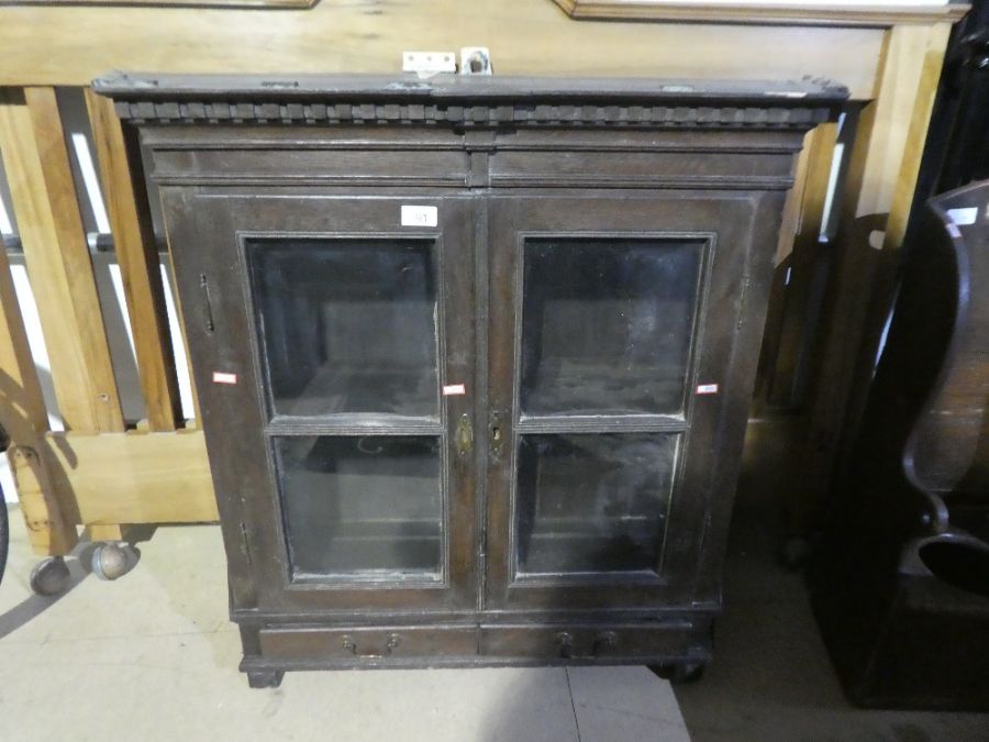 An antique oak glazed bookcase having two drawers, a small child's chair and a stool