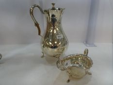 A large silver Mappin and Webb Edwardian hot water pot of baluster form. The rim has a scallop desig
