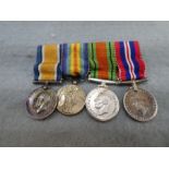 A pair of World War I medals, a pair of World War II medals and four matching miniatures, all un-nam