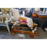 A Victorian style dappled Rocking Horse on pitch pine base, (horse 117 cms)
