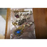 Bag of mixed costume jewellery including 6 silver charms, silver bracelet, plated cufflinks, etc