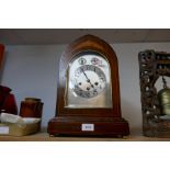 An Edwardian inlaid mahogany mantel clock having arched top with chiming movement