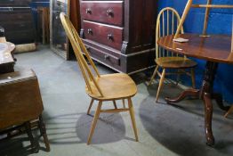 A set of four Ercol stick back chairs, having elm seats