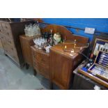 An early 20th century walnut single wardrobe with mirror door and a mahogany sideboard with central