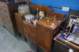 An early 20th century walnut single wardrobe with mirror door and a mahogany sideboard with central