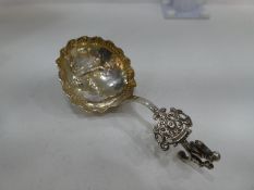 A silver highly decorative spoon, possibly Dutch with the Minerva mark, having pierced design handle