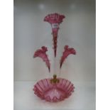 A Victorian cranberry glass epergne with three trumpets
