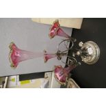 An early 20th Century silver plated and cranberry glass epergne having four trumpets