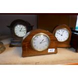 A 1930's oak mantel clock by Camerer Cuss, height 20cms and three others