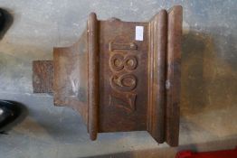 An old cast iron hopper, marked 1897