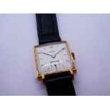 A 9ct gold head Avia wristwatch with a black strap. The face having numerical and baton hour markers