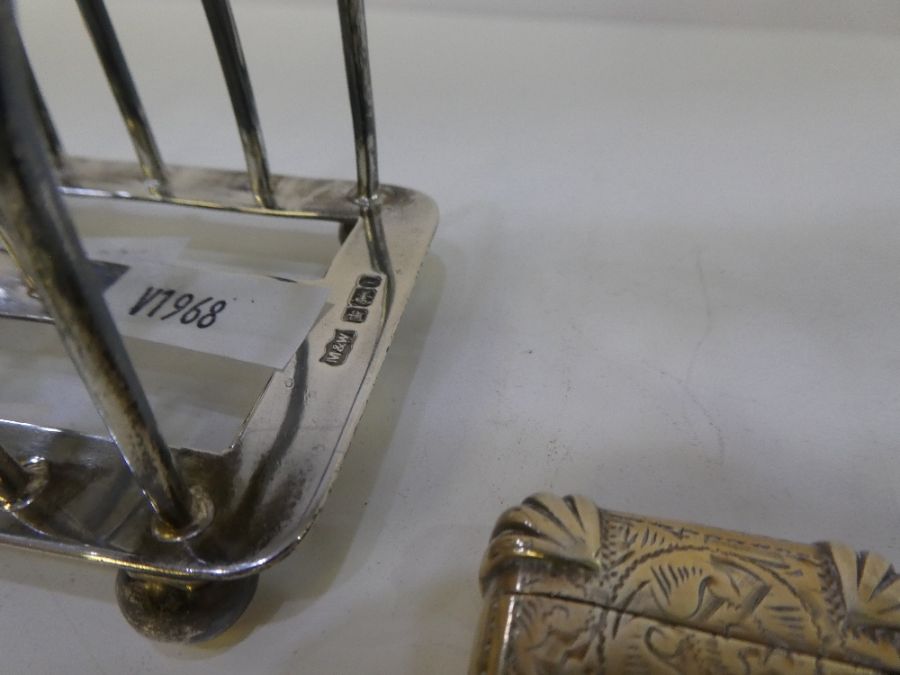 A silver toast rack by Mappin and Webb, on four ball feet. With a heavily decorated Victorian Vesta - Image 4 of 5