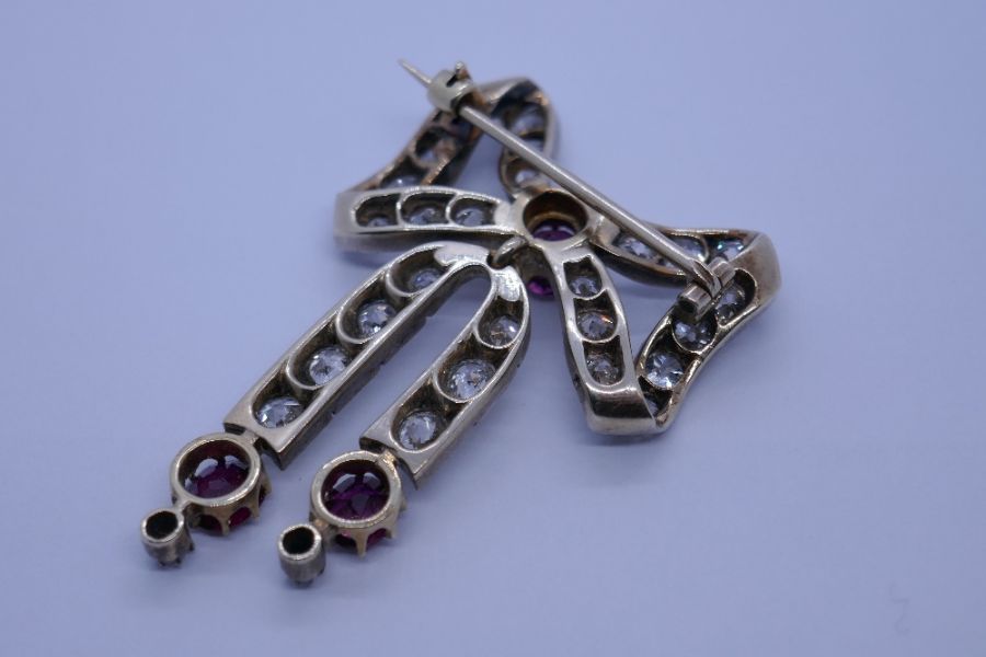 An impressive Victorian ruby and diamond brooch, with form of a bow with central round cut ruby surr - Image 5 of 8