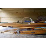 Old wooden oars, badminton rackets and similar