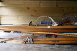 Old wooden oars, badminton rackets and similar