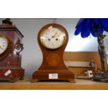 An Edwardian inlaid mahogany balloon shaped mantel clock