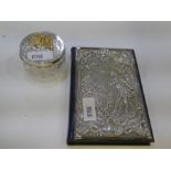 An exceptional leather address book with a decorative silver cover highlighting a romantic scene of
