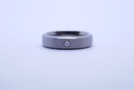 Modern Titanium wedding band inset with a clear stone size V, marked Ti
