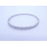 French 18ct white gold hinged bangle inset with 17 diamonds, approx 0.10 carat each, each separated