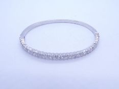 French 18ct white gold hinged bangle inset with 17 diamonds, approx 0.10 carat each, each separated