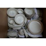 A box of Denby dinnerware decorated white flowers