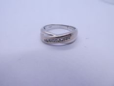 18ct white gold crossover design ring chanel set with 7 small brilliant cut diamonds, approx. 0.25 c