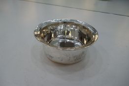 A Liberty and Co silver bowl, circular having deep rounded sides. The rim with a decorative pattern,