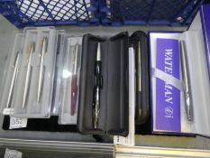 A Waterman stainless steel roller ball pen and quantity of Parker pens and others