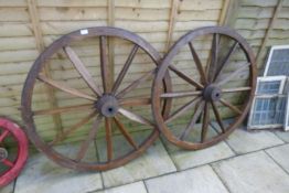 A pair of iron bound large cart wheels