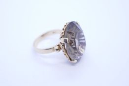 18ct yellow gold cocktail ring set with large oval mixed cut smokey topaz in 4 claw raised mount and