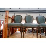 A set of four late Victorian walnut dining chairs on fluted front legs