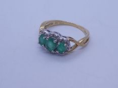 9ct yellow gold emerald trilogy ring, with 3 oval graduated cut emeralds framed diamond chips, marke