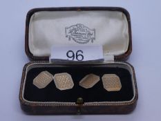 Pair of 9ct yellow gold tapered square cufflinks with machined decoration marked 9ct, maker EAP, in