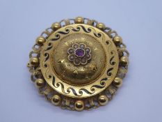 Antique yellow gold circular mourning brooch with central decorated dome inset ruby surrounded seed