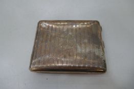 A silver striped pattern cigarette case having central cartouche initialled and gilted interior. Hal