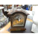 A 1920s oak mantle clock having silvered dial with presentation plaque from the Royal Scot Fusillier
