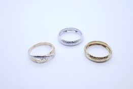 Three 9ct gold rings to include white and yellow gold wedding bands, all marked 9K